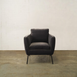 Black armchair with high black metal legs to hire for events in London