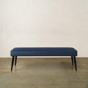 Blue velvet soft padded bench with wooden legs available for event hire