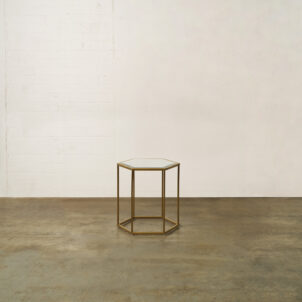 Brass side table with a mirrored top in a hexagonal shape for furniture event hire