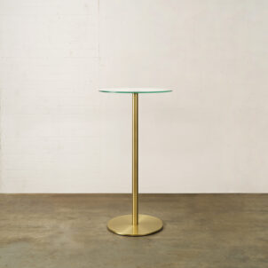 Poseur table with a round glass top and brass base available to hire for events in London