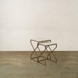 Two side tables with a square marble top and brass geometric legs available to hire for events