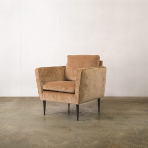 Pale rust chenille armchair with high armrests and dark wooden legs